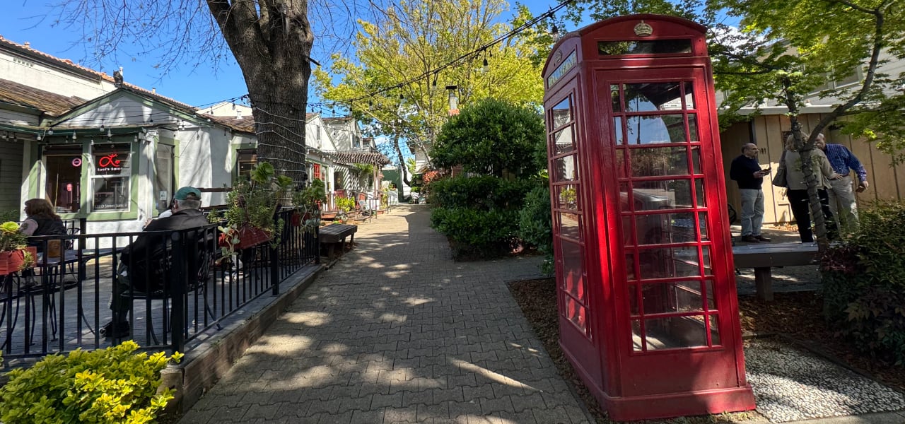 young person using map on a phone in a town street